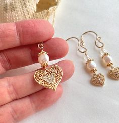 "Elevate your elegance with this beautiful minimalist gold heart necklace and earrings set with white pearls. The dainty 18K gold-plated brass cubic zirconia heart pendant adds a touch of sophistication, complemented by a 16\" gold-plated chain with a secure lobster clasp. The handmade earring hooks feature 10K gold-filled wire, adorned with fresh water pearls, aura Quartz, and gold-plated beads for a delicate and timeless design. This listing offers a gold heart jewelry set, providing the perfe Gold Heart Jewelry, Heart Jewelry Set, Handmade Earring, Gold Heart Necklace, Water Pearls, Aura Quartz, Earring Hooks, Pink Pearl, Gold Heart