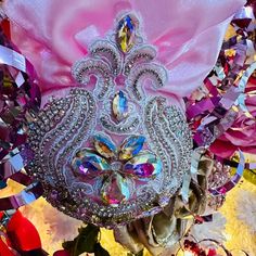 a close up of a pink purse with jewels on it