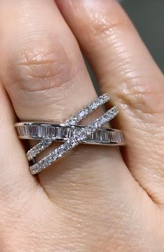 a woman's hand with a diamond ring on top of her finger and the band is in white gold