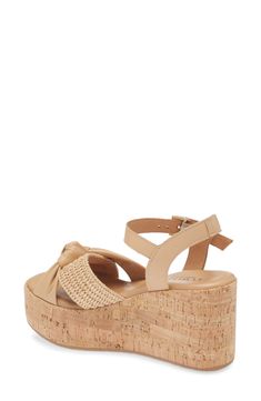 A cork-textured platform enhances the earthy style of a lightly cushioned sandal topped with leather and raffia straps. 3" heel; 1 1/2" platform Cushioned footbed Leather and raffia upper/leather lining/rubber sole Made in Italy Cork Open Toe Wedge Sandals For Beach, Open Toe Cork Wedge Sandals For Beach, Cork Wedge Heel Sandals For Summer, Chic Cork Wedge Sandals With Open Toe, Cork Wedge Sandals For Summer, Chic Open Toe Cork Wedge Sandals, Spring Beach Wedge Sandals With Cork Material, Summer Cork Wedge Sandals, Spring Beach Cork Wedge Sandals