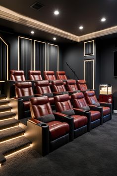 an empty theater with red leather seats and steps leading up to the screen on the wall