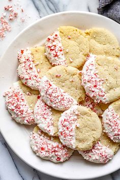 a white plate filled with peppermin cookies on top of a marble counter