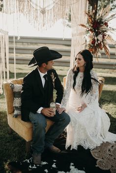 a man and woman sitting on a bench in front of a cowgirl's head