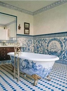 an ornate bathroom with blue and white tiles on the walls, floor, and bathtub