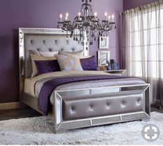 a bedroom with purple walls and silver furniture