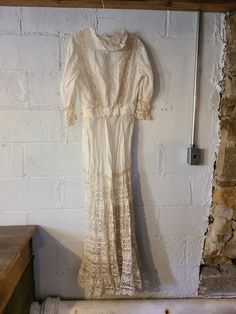 This antique dress from the 1800s is beautiful. It is lightweight cotton and Victorian. It is long with long sleeves. Look at the lace with boho style on the bottom and the beautiful monotone floral embroidery. This dress needs cleaned and loved on, repaired to bring it back to it Glory. This is a beauty to have pictures taken in. I don't know the size. More Vintage Fashion: https://www.etsy.com/shop/MollyFinds?ref=seller-platform-mcnav&section_id=17396831 Dresses From The 1800s, Simple Gift Wrapping, Antique Dress, Lace Flowers, Boho Stil, Floral Embroidery, Vintage Gifts, Dress Clothes For Women, Lace Dress