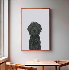 a black dog is hanging on the wall above a table