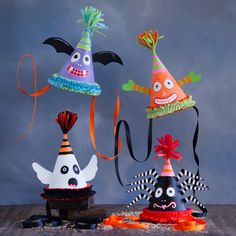 three halloween hats with faces and decorations on them