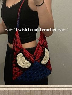 a woman is taking a selfie with her cell phone while wearing a crocheted bag