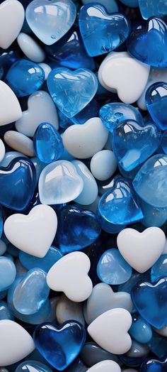 blue and white glass hearts are scattered on top of each other in this close up photo