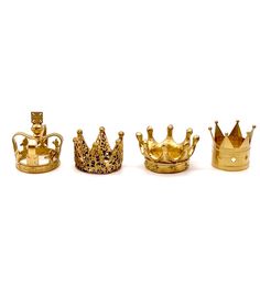 four gold crowns sitting next to each other