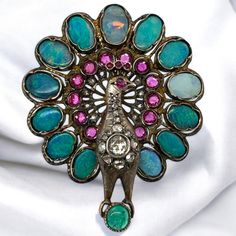 This brooch is so intricate and thought out! He is accented by an array of gemstones, including a hidden sapphire behind the head! Brooch Details Material: 14K Gold & Silver Top Era: Georgian 1714 - 1840 Height: 2 Inches Width: 1.75 Inches Weight: 20.4 Grams Item: 768TMV8-AT Peacock Colored Wedding Brooch Jewelry, Antique Multi-stone Brooches For Wedding, Victorian Multi-stone Wedding Brooches, Peacock Brooch, Georgian Era, Silver Top, Ruby Emerald, Silver Tops, Emerald Diamond