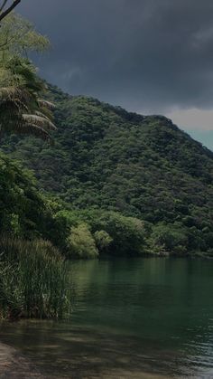 an image of a lake with trees and mountains in the background