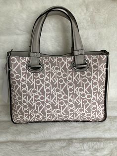 Calvin Klein Lucia 🤩Monogram Print Tote Bag Satchel Handbag Purse. NEW. Retail price $198.00 Calvin Klein Lucia Tote 12" W x 9" H x 5"D; 2 lbs Magnetic snap closure 5" handle drop; 23" adjustable detachable crossbody strap 3 interior slip pockets, 1 zip pocket, 1 card slot with detachable pouch💫 1 back slip pocket Silver-tone hardware PVC Spot clean Imported Logo Character, Faux Leather Bag, Satchel Handbag, Bags Logo, Monogram Prints, Monogram Styles, Satchel Handbags, D 2, Print Tote