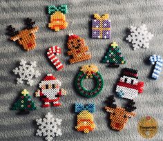 cross stitch christmas ornament kits on a gray blanket with snowflakes and ornaments