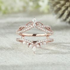 a rose gold wedding ring set with pear shaped diamonds