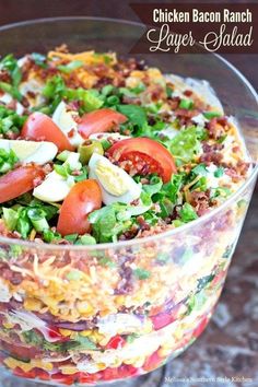 chicken bacon ranch layer salad in a glass bowl on a table with text overlay