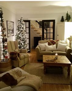 a living room filled with furniture and a christmas tree