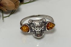 This beautiful silver ring combine a unique  animal design decorated with genuine Baltic amber.Funky but glamourus Jaguar amber ring ,ready for many occasions . Material ; Genuine Baltic amber with oxidized sterling silver Size of the ring  :  7 1/4  ,   US Dimensions  Head ;  10 x 10 mm Finish  ;  polished All our product handcrafted ,manually processing. Jaguar Jewelry, Animal Unique, Fox Ring, Jaguar Animal, Beautiful Silver Rings, Amber Ring, Tiny Hand, Cute Rings, Unique Animals