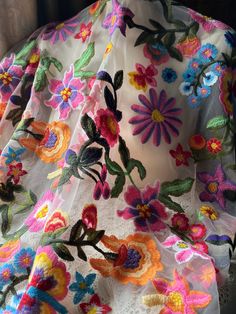 a white dress with colorful flowers on it