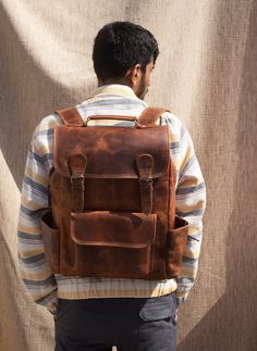 Leather Backpack, Handmade Leather Rucksack, Personalised Leather Laptop Backpack, Leather Trekking Backpack, Leather Hiking Bag Men Women Dimensions: 12 X 16 X 5 Inches The Leather Backpack is beautifully crafted while ensuring the durability and utility respective to all kinds of outdoor activities. The product is made by using 100 % Buffalo Full Grain leather with Polyester lining. We have used premium quality Waxed Buffalo leather. The Backpack contains 2 spacious compartments for books, fil Vintage Backpack With Leather Backing, Leather Backed Backpack For Everyday Use, Rugged Leather Backpack For Travel With Adjustable Strap, Classic Large Capacity Leather Backpack, Rugged Leather Travel Backpack With Adjustable Strap, Large Capacity Classic Leather Backpack, Leather Backpack For Travel, Rugged Backpack For Everyday Use, Classic Leather Backpack With Flap