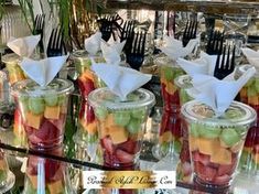 many glasses filled with different types of fruit