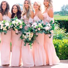 the bridesmaids are all wearing pink dresses and holding bouquets in their hands