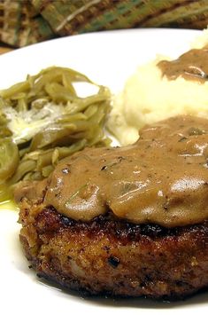 meatloaf with gravy and mashed potatoes on a plate