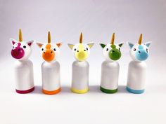 five plastic unicorns are lined up in a row