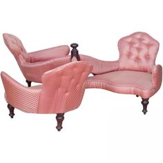 two pink chairs and one chair with an arm rest