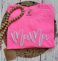 I love this Neon Pink Mama tee with 3D puff embroidery!  The perfect tee for Summer! Made with LOVE in Oklahoma.   Comfort Color 6.1 oz 100% ring spun cotton. Unisex sizing for a relaxed fit. Suggested sizes: S (0-4) M (6-10) L (10-14) XL (14-18) *Processing TIme* Please allow 5-7 days for production.  We ship USPS, normally allow up to 7 days for shipping. *Care Instructions* Wash inside out, cold.  Lay flat to dry.  Lightly iron if necessary, but NOT over the embroidery Return/Exchange Policy: Casual T-shirt With Embroidered Text For Mother's Day, Pink T-shirt With Embroidered Text For Summer, Mother's Day Pink Graphic Tee, Cotton T-shirt With Letter Embroidery For Birthday, Pink Embroidered T-shirt For Summer, Cute Pink T-shirt With Letter Embroidery, Pink Summer Tops With Embroidered Graphics, Pink Crew Neck T-shirt With Embroidered Graphics, Pink Casual T-shirt For Mother's Day