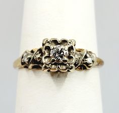 an antique diamond ring is sitting on a napkin