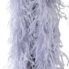 the back of a woman's coat with white feathers