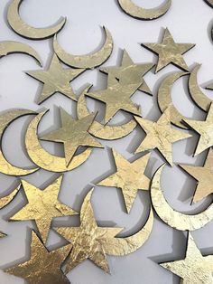 gold stars and crescents are arranged on a white surface