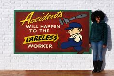 a woman standing next to a sign that says accident will happen to the careless worker