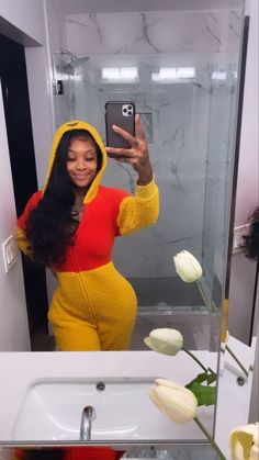 a woman taking a selfie in front of a bathroom mirror wearing a winnie the pooh costume