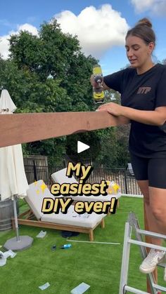 a woman holding onto a wooden fence with the words my easiest diy ever on it