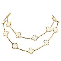 Van Cleef & Arpels 18K Gold Vintage White Coral 20 Motif Alhambra Chain Necklace. Circa 1985. With accommodating VCA paperwork. A very rare 20-motif Alhambra necklace in White Coral, Van Cleef & Arpels. One of the most popular designs from the house of Van Cleef & Arpels is as popular today as in 1968 the year it was created. It is composed of 20 clover-shaped motifs in creased yellow gold and trimmed with gold beads. This symbolic design achieved immediate success, recognized throughout the wor Van Cleef And Arpels Butterfly Necklace, Luxury White Necklace With Chain Detail, White Designer Jewelry With 17 Jewels, Designer White Jewelry With 17 Jewels, Luxury White Necklaces, Luxury White Hallmarked Jewelry, Luxury White Necklace, Luxury White 14k Gold Necklaces, Luxury White 14k Gold Necklace