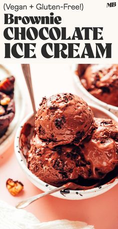 chocolate ice cream is in a bowl with spoons on the table next to it