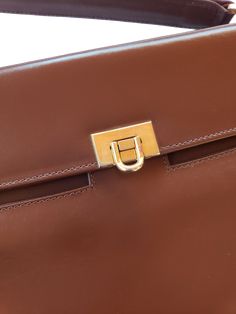 Details: Brand: I.Magnin (Made in Italy) Cocoa Brown Leather Length: 11.25" Height: 8" Width: 1.5 - 3.5" Accordian style interior Metal clasp Cross-body Strap included Interior center zip pocket Small zip interior pocket Small Patch interior pocket Designer Brown Flap Bag For Business, Brown Flap Bag With Gold-tone Hardware For Business, Business Brown Flap Bag With Gold-tone Hardware, Designer Handheld Flap Bag For Formal Events, Designer Handheld Flap Bag For Formal Occasions, Designer Brown Briefcase With Gold-tone Hardware, Classic Brown Briefcase With Gold-tone Hardware, Brown Business Briefcase With Gold-tone Hardware, Brown Briefcase With Gold-tone Hardware For Business