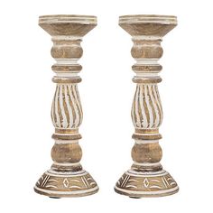 two wooden candlesticks sitting next to each other