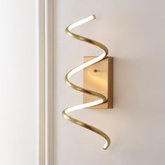 a wall light that is on the side of a door with a spiral design on it