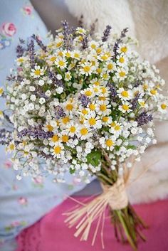 a bouquet of flowers sitting on top of a bed