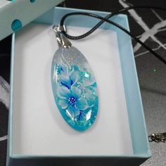 Original necklace made of epoxy resin and hand-painted flora composition by the artist Olga Gineva. Height = 2 inch = 5 cm Width = 1 inch = 2.5 cm Chain length = 12 inch= 30 cm Weight = 0.35 ounces = 10 gram It is sold in a gift box, making it the perfect present or a delightful indulgence for yourself. ✿ MORE OF MY ART: https://www.etsy.com/shop/PaintingsInspiration ❤ Thanks for visiting my store! And I hope you find what you love here :-) Hand Painted Blue Round Pendant Necklace, Hand Painted Blue Jewelry For Gifts, Blue Hand Painted Round Pendant Necklace, Blue Hand Painted Jewelry Gift, Blue Hand Painted Jewelry As A Gift, Blue Hand Painted Jewelry For Gift, Artistic Hand-painted Turquoise Jewelry, Artistic Hand Painted Turquoise Jewelry, Hand Painted Resin Jewelry For Gifts