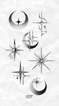 some black and white drawings on paper with stars, crescents and moon shapes in the middle