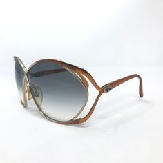 Brand: Christian Dior Model: 2056 44 Colour: Gold and brown. See photos for colour, pattern and detailing Rim Type: Full rim Gender: Women Frame Material: Metal & Plastic Lens Width: 66 mm *please note this is an approximate measurement as it has been hand measured Bridge: 20 mm *please note this is an approximate measurement as it has been hand measured Temple/Arms: 110 mm  See photos for frame width and lens height Condition: These are wonderful vintage sunglasses, they have been previously us Dior Model, Vintage Christian Dior, Colour Pattern, Vintage Sunglasses, Gold Sunglasses, Sunglasses Vintage, Vintage Frames, Eyewear Sunglasses, Christian Dior