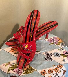 This is a vintage pair of women's mule heel shoes from the 1990s. They are marked not marked with a maker's name or size. Purchased on a trip to Japan in the 90s. Made of a lacquered wood composition base, hand painted in red with black & white stripes & flowers. The vamps across the toes are red flocked fabric that are beaded & sequined. The have 3" stiletto heels & open toes, slip-on style. The soles measures 9-3/4" long on the inside & are 2-3/4" wide across the ball of the foot on the outside of the sole. About a US size 5-1/2. soles have a plastic tread & heels have metal & plastic caps.  They are very good, vintage condition. Showing little to no wear. Please see photos for details. Charming! Vintage Red Heels For Spring, Traditional High Heel Spring Heels, Traditional High Heels For Spring, Vintage Slip-on Heels For Spring, Traditional Open Heel Spring Heels, Traditional Spring Open Heel Heels, Vintage Pointed Toe Mules, Japan In The 90s, Mule Heel