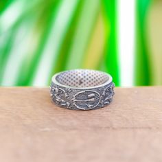 a silver ring sitting on top of a wooden table