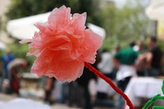 a flower that is on top of a pole