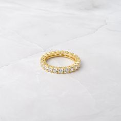 Beautiful eternity band, that sparkles and glistens like no other! Looks great on its own or paired with other rings! - - - D E T A I L S - - -  * Made of 925 Sterling Silver * We use a Durable, THICK plating of 14k Gold or Rhodium - for a piece that will last you years to come!  * Stone measures 3mm  * Eternity-style band  * Nickel-free & Hypoallergenic * Available in sizes 4-12 Ring Sizer- https://www.etsy.com/listing/1240904225/ring-sizer-reusable-ring-sizer-plastic?click_key=b5e074cfb419bcfd Minimalist Diamond White Eternity Band For Promise, Minimalist Diamond White Eternity Band Promise Ring, Vs Clarity Round Band Promise Ring, White Eternity Band With Vs Clarity, Half Eternity Cubic Zirconia Band, White Vs Clarity Round Eternity Band, Gold Stackable Eternity Band With Cubic Zirconia, Cubic Zirconia Half Eternity Stackable Promise Rings, Gold Cubic Zirconia Stackable Eternity Band